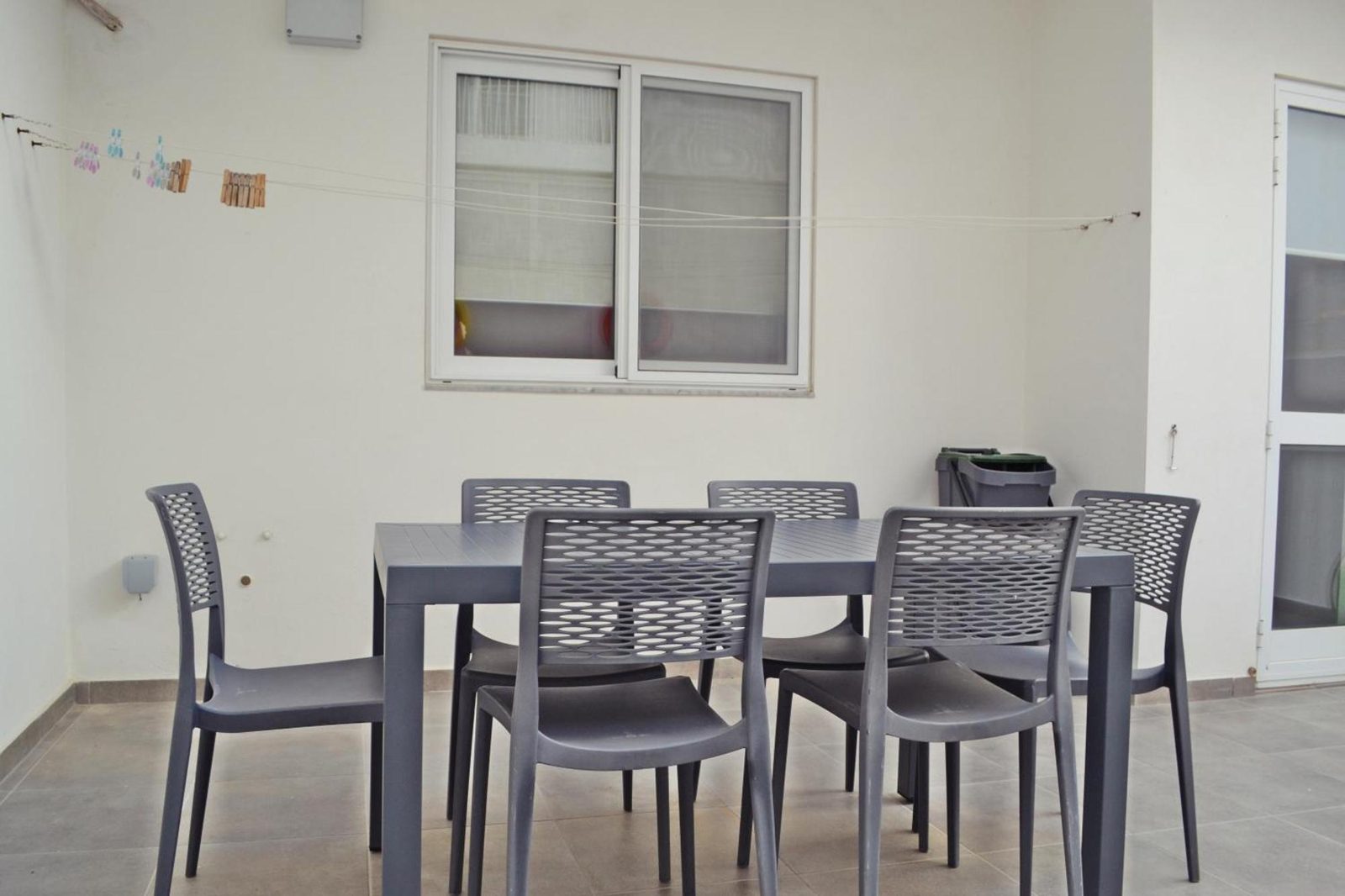 Outdoor dining area with table and chairs in the back courtyard
